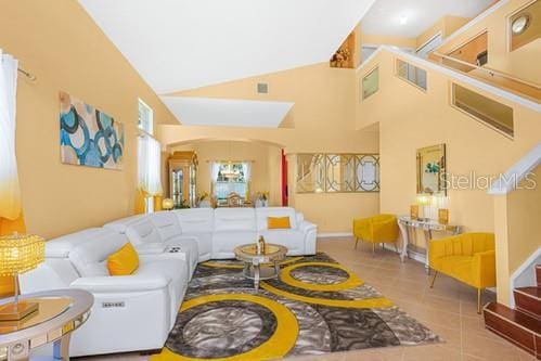 7 Flint Pl, Palm Coast, FL 32137 - tiled living room with high vaulted ceiling and arched walkways