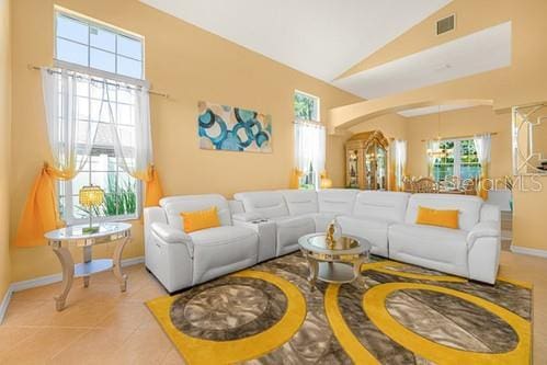 7 Flint Pl, Palm Coast, FL 32137 - tiled living room featuring baseboards and lofted ceiling