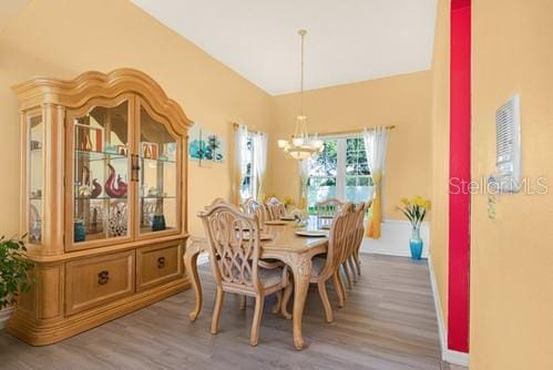 7 Flint Pl, Palm Coast, FL 32137 - dining area with a chandelier and light wood-type flooring