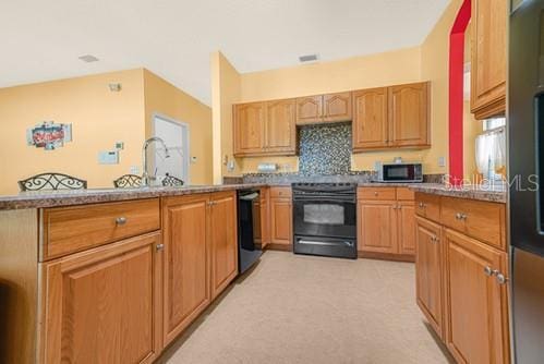 7 Flint Pl, Palm Coast, FL 32137 - kitchen featuring black appliances, light colored carpet, and decorative backsplash