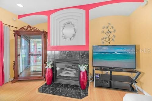 7 Flint Pl, Palm Coast, FL 32137 - living area featuring wood finished floors, recessed lighting, and a tile fireplace