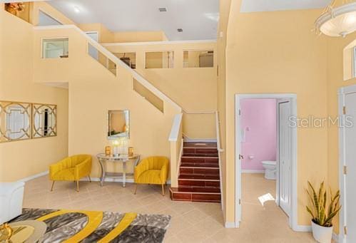 7 Flint Pl, Palm Coast, FL 32137 - tiled living area featuring stairs and baseboards