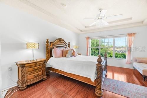 7 Flint Pl, Palm Coast, FL 32137 - bedroom featuring wood finished floors, a raised ceiling, and a ceiling fan