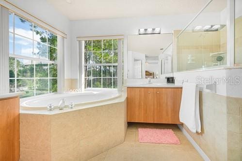 7 Flint Pl, Palm Coast, FL 32137 - full bathroom featuring vanity, a tile shower, and a garden tub