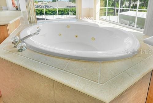 7 Flint Pl, Palm Coast, FL 32137 - full bathroom featuring plenty of natural light and a tub with jets