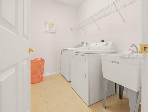 7 Flint Pl, Palm Coast, FL 32137 - washroom with washing machine and dryer and baseboards