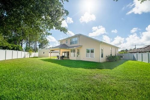 7 Flint Pl, Palm Coast, FL 32137 - back of house featuring a fenced backyard and stucco siding