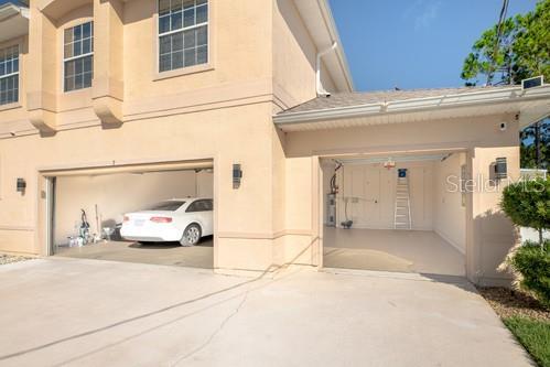 7 Flint Pl, Palm Coast, FL 32137 - view of side of property featuring driveway, stucco siding, and an attached garage