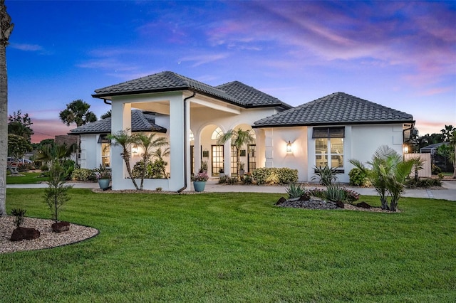 33 Crystal Bay Ct, Palm Coast, FL 32137 - back of property featuring stucco siding, a lawn, and a tiled roof