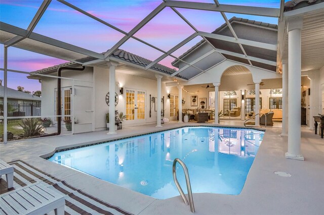 33 Crystal Bay Ct, Palm Coast, FL 32137 - pool at dusk with french doors, an outdoor pool, an outdoor hangout area, a patio area, and ceiling fan