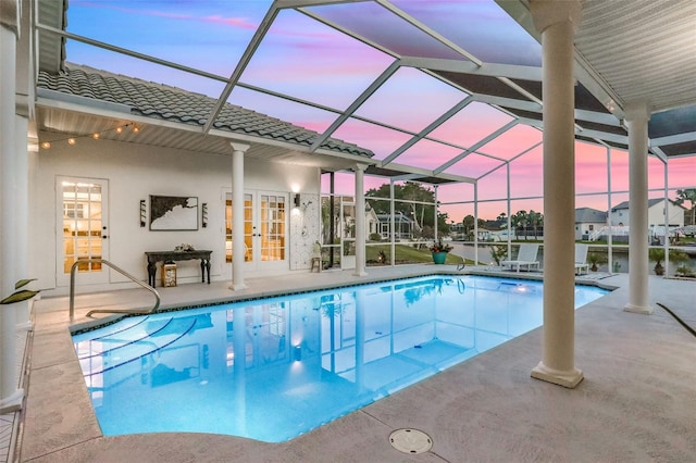 33 Crystal Bay Ct, Palm Coast, FL 32137 - pool at dusk with french doors, an outdoor pool, and a patio