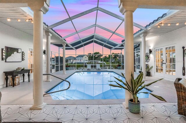 33 Crystal Bay Ct, Palm Coast, FL 32137 - pool at dusk featuring french doors, a patio, an outdoor pool, and a lanai