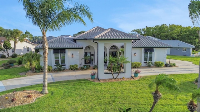 33 Crystal Bay Ct, Palm Coast, FL 32137 - back of property with a yard, a tile roof, stucco siding, and concrete driveway