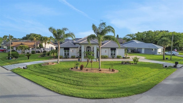 33 Crystal Bay Ct, Palm Coast, FL 32137 - mediterranean / spanish-style house featuring a front lawn, curved driveway, and stucco siding