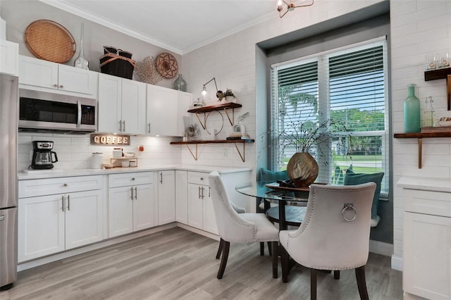 33 Crystal Bay Ct, Palm Coast, FL 32137 - dining area with ornamental molding and light wood-type flooring