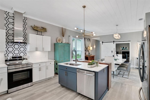 33 Crystal Bay Ct, Palm Coast, FL 32137 - kitchen with stainless steel appliances, white cabinetry, light wood-style floors, and ornamental molding