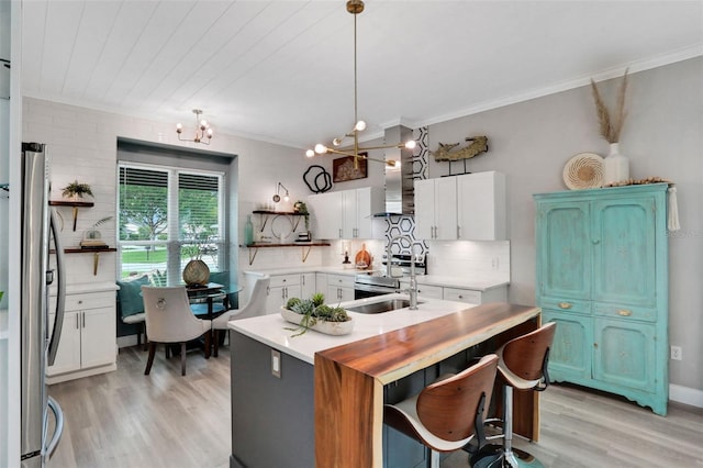 33 Crystal Bay Ct, Palm Coast, FL 32137 - kitchen featuring crown molding, light wood-type flooring, open shelves, stainless steel appliances, and light countertops