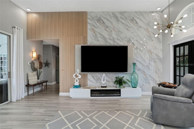 33 Crystal Bay Ct, Palm Coast, FL 32137 - living area with an accent wall, a chandelier, wood finished floors, and recessed lighting