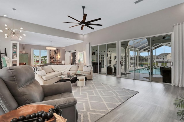 33 Crystal Bay Ct, Palm Coast, FL 32137 - living area with wood finished floors, a ceiling fan, a chandelier, and recessed lighting