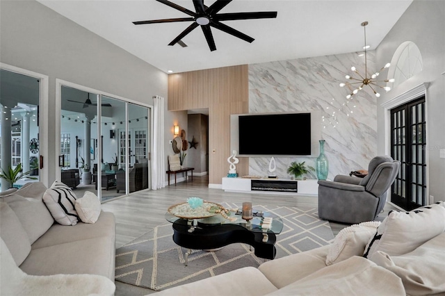 33 Crystal Bay Ct, Palm Coast, FL 32137 - living area with an accent wall, a ceiling fan, wood finished floors, and a chandelier