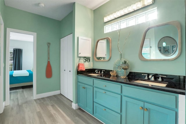 33 Crystal Bay Ct, Palm Coast, FL 32137 - bathroom featuring wood finished floors, double vanity, and ensuite bath