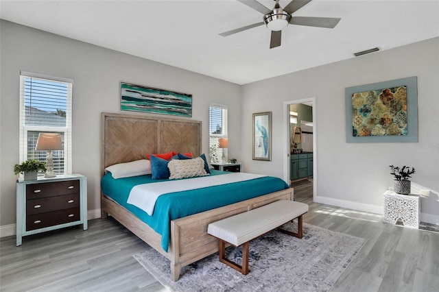 33 Crystal Bay Ct, Palm Coast, FL 32137 - bedroom featuring light wood-type flooring, multiple windows, ceiling fan, and connected bathroom