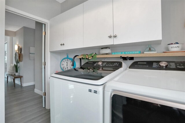 33 Crystal Bay Ct, Palm Coast, FL 32137 - laundry area with washer and dryer and light wood-style flooring