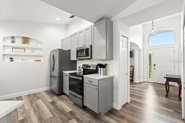 1904 Rouzbeh Ct, Port Orange, FL 32128 - kitchen with stainless steel appliances, gray cabinetry, light countertops, wood finished floors, and recessed lighting