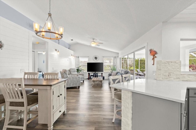 1904 Rouzbeh Ct, Port Orange, FL 32128 - dining space with ceiling fan, vaulted ceiling, dark wood-style floors, a chandelier, and a textured ceiling