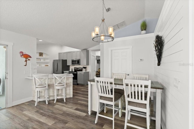1904 Rouzbeh Ct, Port Orange, FL 32128 - dining space featuring vaulted ceiling, a chandelier, dark wood-style flooring, and a textured ceiling