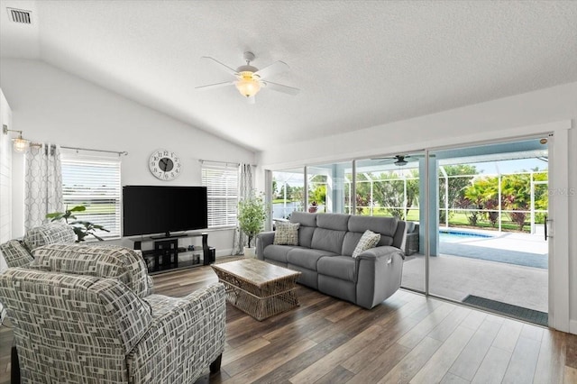 1904 Rouzbeh Ct, Port Orange, FL 32128 - living area with ceiling fan, vaulted ceiling, wood finished floors, healthy amount of natural light, and a textured ceiling