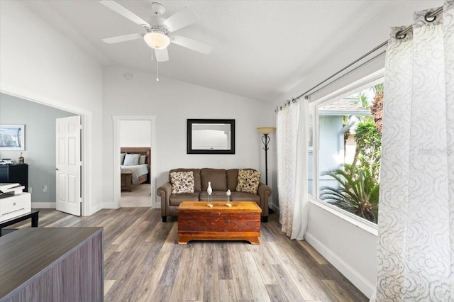 1904 Rouzbeh Ct, Port Orange, FL 32128 - living room with vaulted ceiling, a ceiling fan, and wood finished floors
