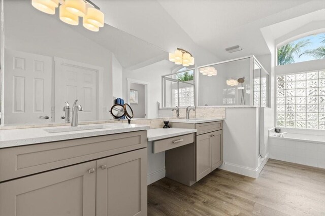 1904 Rouzbeh Ct, Port Orange, FL 32128 - full bath featuring a shower stall, two vanities, wood finished floors, a bath, and vaulted ceiling