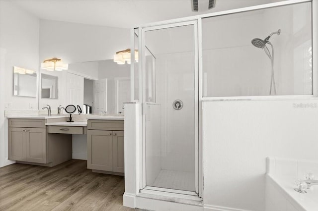 1904 Rouzbeh Ct, Port Orange, FL 32128 - bathroom with a stall shower, vanity, wood finished floors, and a bath