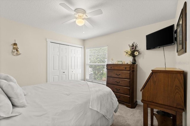 1904 Rouzbeh Ct, Port Orange, FL 32128 - bedroom with light colored carpet, a closet, a textured ceiling, and ceiling fan