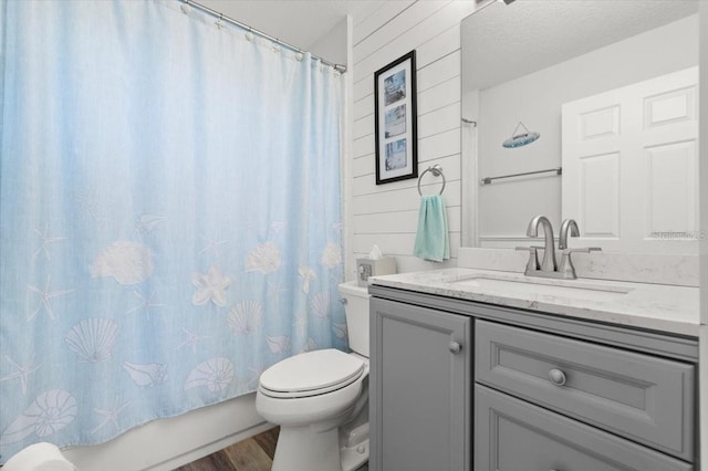 1904 Rouzbeh Ct, Port Orange, FL 32128 - bathroom featuring vanity, wood finished floors, shower / bath combo, and a textured ceiling