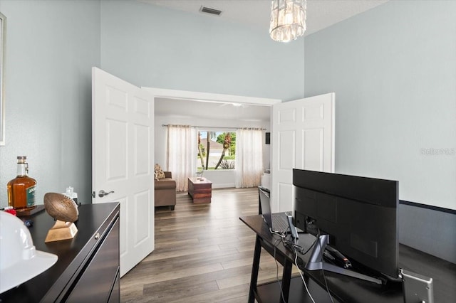 1904 Rouzbeh Ct, Port Orange, FL 32128 - office space featuring wood finished floors, a towering ceiling, and a chandelier
