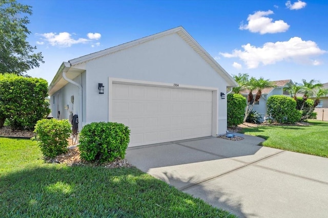 1904 Rouzbeh Ct, Port Orange, FL 32128 - view of side of property featuring stucco siding, a lawn, driveway, and an attached garage
