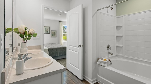 8 Mill Wheel Ct S, Palm Coast, FL 32137 - ensuite bathroom featuring double vanity, washtub / shower combination, and wood finished floors