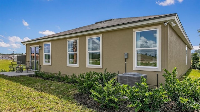 8 Mill Wheel Ct S, Palm Coast, FL 32137 - view of side of home with a patio area, a lawn, and stucco siding