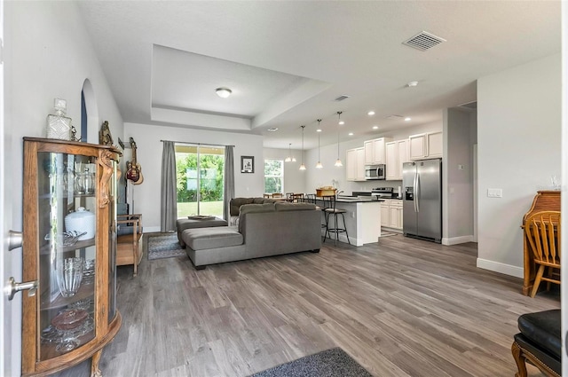 9 Elder Pl, Palm Coast, FL 32164 - living area with wood finished floors, a tray ceiling, and recessed lighting