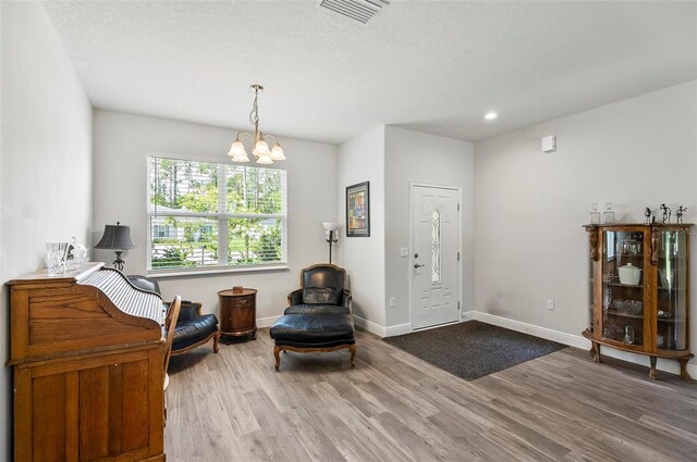 9 Elder Pl, Palm Coast, FL 32164 - sitting room featuring wood finished floors, a chandelier, recessed lighting, and a textured ceiling