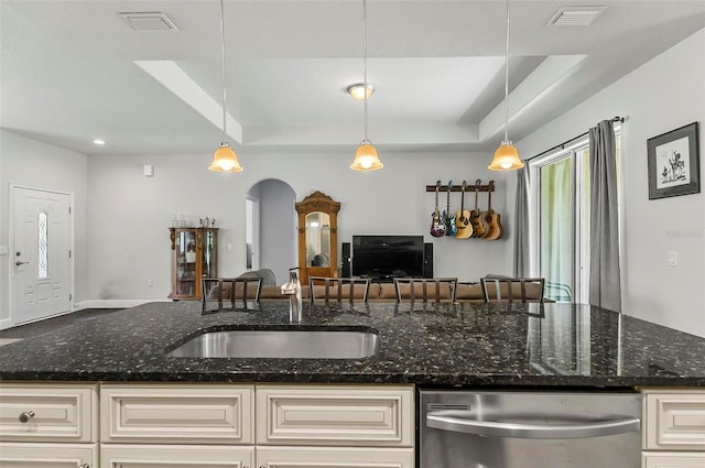 9 Elder Pl, Palm Coast, FL 32164 - kitchen featuring dishwasher, arched walkways, open floor plan, and cream cabinetry