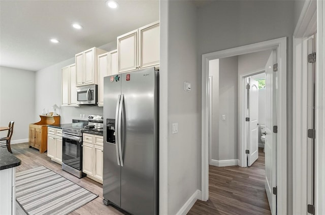 9 Elder Pl, Palm Coast, FL 32164 - kitchen featuring appliances with stainless steel finishes, dark countertops, light wood finished floors, and recessed lighting
