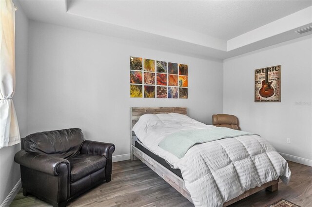 9 Elder Pl, Palm Coast, FL 32164 - bedroom with a raised ceiling and wood finished floors