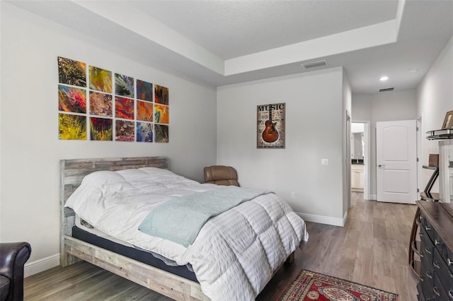 9 Elder Pl, Palm Coast, FL 32164 - bedroom with wood finished floors, a raised ceiling, and recessed lighting