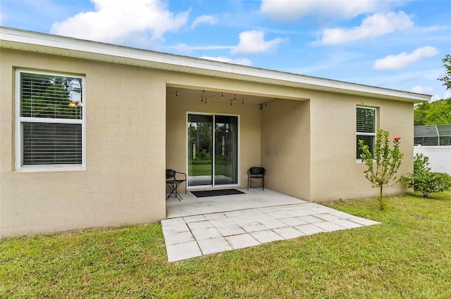 9 Elder Pl, Palm Coast, FL 32164 - rear view of house featuring stucco siding, a patio area, and a yard