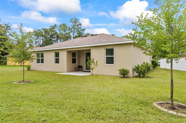 9 Elder Pl, Palm Coast, FL 32164 - rear view of house with stucco siding, a patio, and roof with shingles