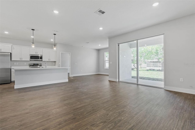 1 Barbera Ln, Palm Coast, FL 32137 - unfurnished living room featuring recessed lighting and dark wood-type flooring