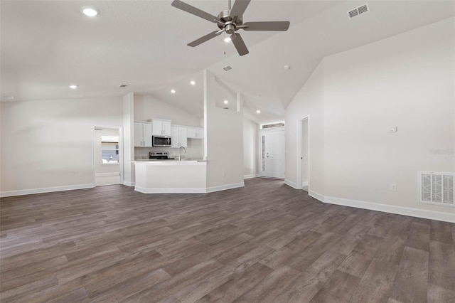 16 Service Tree Pl, Palm Coast, FL 32164 - unfurnished living room with high vaulted ceiling, a ceiling fan, recessed lighting, and dark wood-style flooring